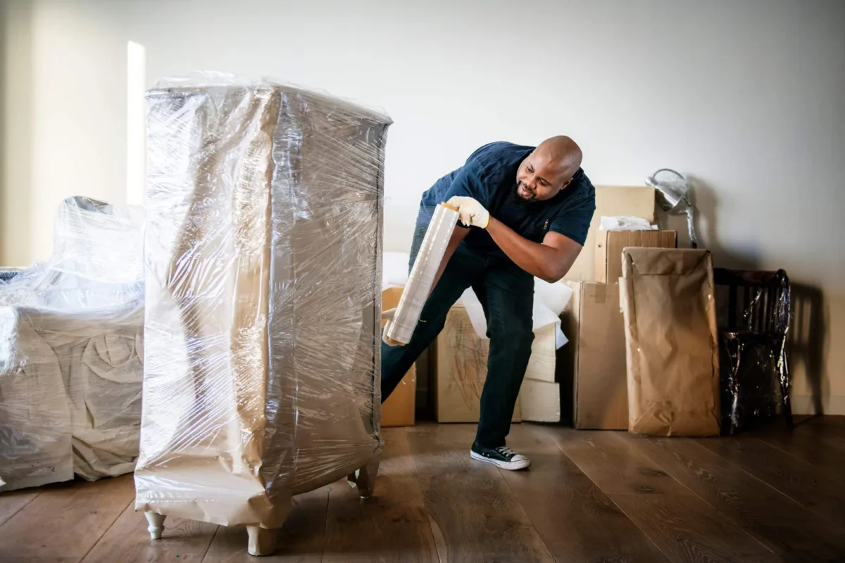 Moving team handling household items and antique furniture in a Kowdiar high-rise